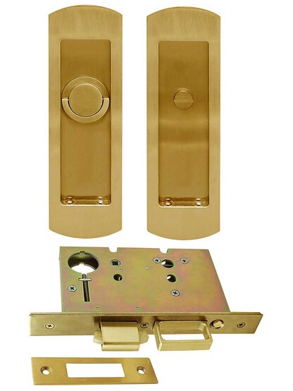 Premium Pocket-Door Mortise Lock Set with Rounded Pulls in Aged Brass.